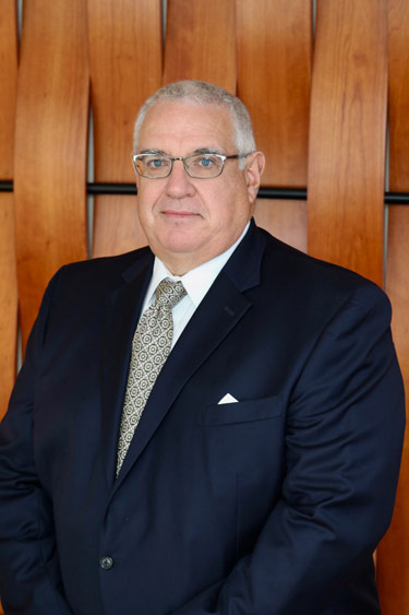 John K. Smith, President & CEO